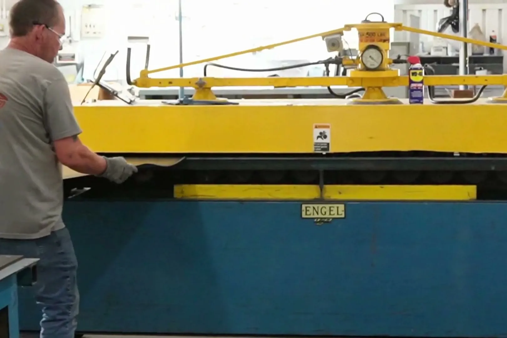 A Belco technician working at the vacuum lift on the Belding shop floor.