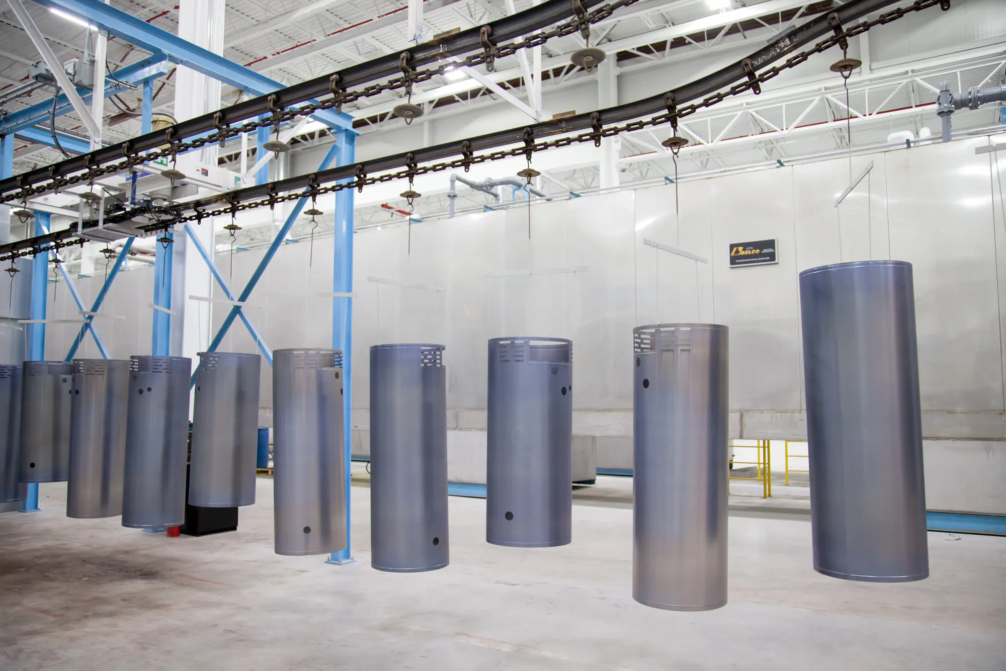 Water heater tanks hanging on the powder coating line at Bradford White.